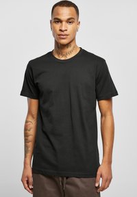 Sort bomulds T-shirt med korte ærmer, rund halsudskæring og en afslappet pasform. Har en glat tekstur, ingen mønstre eller udsmykninger.