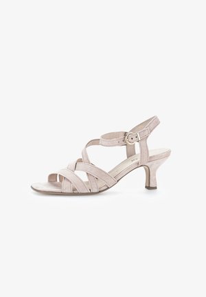 Beige semišové sandály na podpatku mají křížové pásky, otevřenou špičku, nastavitelný pásek kolem kotníku s přezkou a štíhlý podpatek.