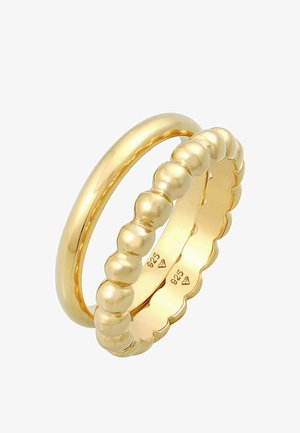 Zestaw złotego pierścionka składający się z gładkiej obrączki i wzoru koralikowego. Oba pierścionki oznaczone są napisem "925" na wewnętrznej powierzchni, co wskazuje na srebro sterlingowe.