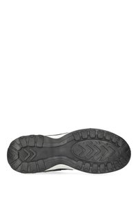 Sole of a black and white sneaker showing tread pattern with chevron and block shapes on a white background.