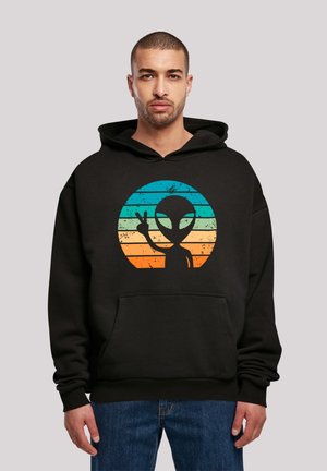Black hoodie featuring a front pocket and a graphic of an alien silhouette against a gradient background of blue and orange stripes.