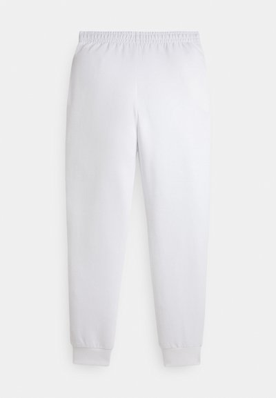 Bijele trenirke s elastičnim pojasom i rebrastim manšetama, prikazane na jednostavnoj bijeloj pozadini.