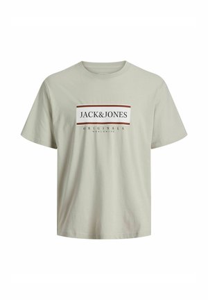 Light beige short-sleeve cotton T-shirt with a round neck, featuring "JACK & JONES ORIGINALS WORLDWIDE" text on the chest in a rectangular design.