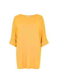 T-shirt jaune surdimensionné avec des manches courtes retroussées et un col rond. Fabriqué en tissu doux avec une texture lisse.