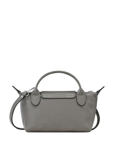Gray leather handbag with rounded handles, detachable shoulder strap, and a flap closure featuring embossed logo detail. Compact design.