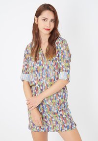 Vestido colorido y estampado con un diseño de hojas en verde, azul y rojo, de corte holgado, con mangas cortas y escote en V.