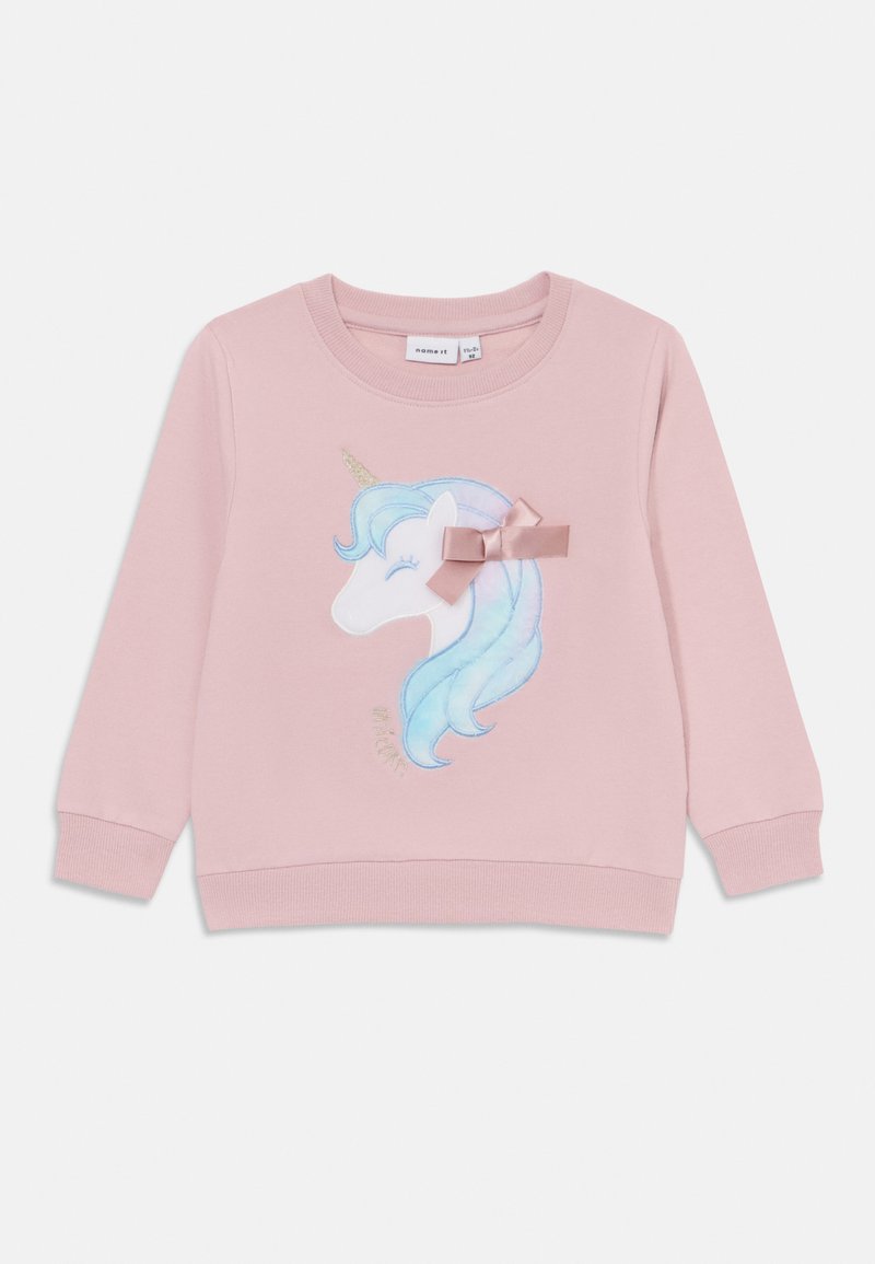 Felpa rosa con un design di unicorno, dotato di criniera blu, corno dorato e un fiocco rosa chiaro. Tessuto morbido con polsini e orlo a coste.