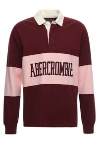 Bordeauxrode en roze lange mouw polo met een witte kraag. Heeft een opvallend "ABERCROMBIE" logo op de voorkant. Zachte katoenen stof.