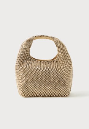 Petit sac à main doré recouvert de clous ronds brillants avec une poignée courte et une découpe rectangulaire en haut.