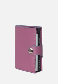 Compact pink wallet made of textured leather with a snap closure, including an RFID protection card slot and contrasting blue edge stitching.