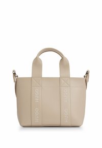 Beige leather handbag with dual top handles and detachable shoulder strap. Features diagonal stitching and "HUGO" logo accents embossed on sides.