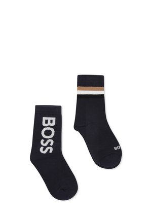 Navy blue cotton blend socks featuring a large "BOSS" logo on one and a striped top in beige, white, and black on the other.