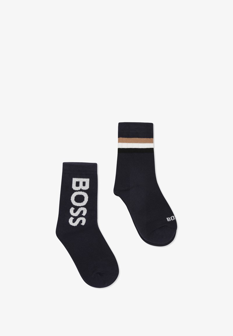 Chaussettes en mélange de coton bleu marine présentant un grand logo "BOSS" sur l'une et un haut rayé en beige, blanc et noir sur l'autre.