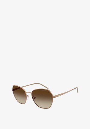 Gafas de sol de oro rosa con montura octagonal, lentes marrones degradados y varillas metálicas delgadas. Incluye almohadillas nasales para mayor comodidad y detalles de la marca.