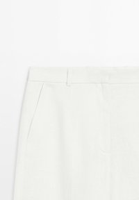 White dress pants with a waistband, belt loop, and side pocket, shown from the waist to mid-thigh on a plain white background.