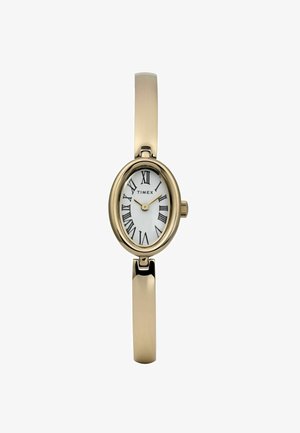 Zelta tonis Timex ovāla pulksteņa ar baltu ciparnīcu, melniem romiešu cipariem un gludu metālisku rokassprādzi. Iekļauj sānu kroni regulēšanai.