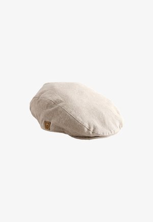 Beige flat cap lavet af tekstureret stof med et lille brunt mærke med et bjørnehovedlogo på siden.