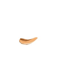 Krämig beige kosmetikprodukt, slät yta, böjd form, glänsande textur, applicerad i ett tunt lager mot en vit bakgrund.