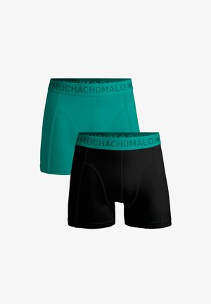 Férfi boxeralsók petrol és fekete színben, puhán rugalmas derékkal, amelyen a "MUCHACHOMALO" márkaneve található, sima textúrával és testhezálló fazonnal.