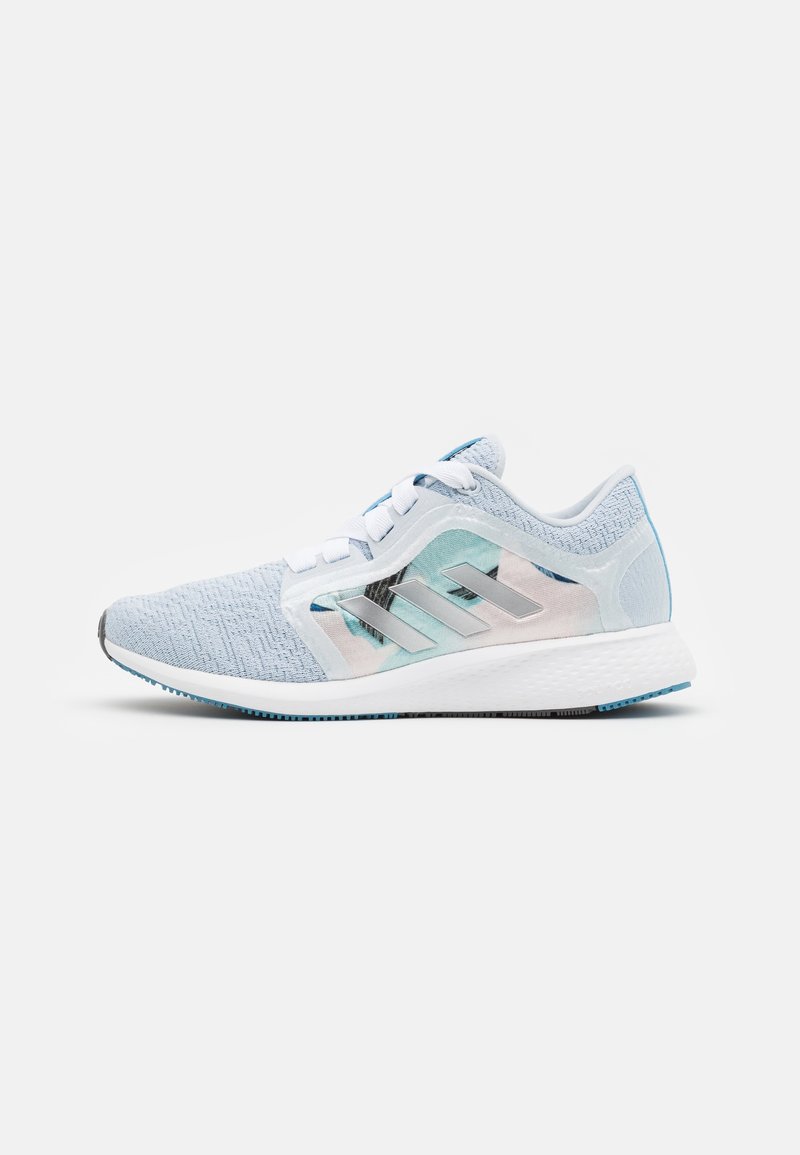 Light blue running shoe with a textured upper, white laces, and silver accents. Features a patterned side panel and a cushioned sole.