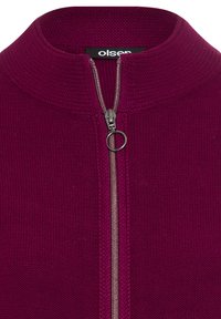 Zippered pullover in deep magenta, textured knit fabric, featuring a high collar and silver zipper detail at the front.