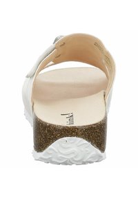 White open-back sandal featuring a cork midsole, soft footbed, and a smooth leather upper with adjustable strap and rubber outsole.