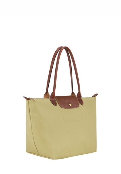 Yellow nylon tote bag with brown leather accents and handles, featuring a zip top closure and a smooth, matte texture.
