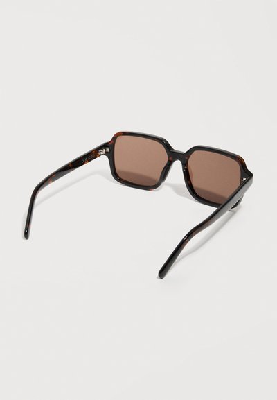 Tortoiseshell square-frame sunglasses with brown tinted lenses resting on a white surface.