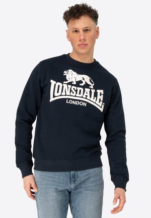 Navy blue sweatshirt with a crew neckline, featuring a large white lion logo and "LONSDALE LONDON" text. Made from a textured fabric.