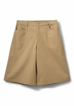 Beežist puuvillast lühikesed püksid, sirge lõikega, nupu ja tõmblukuga sulgemine, kaks eesmist taskut ning ilma nähtavate mustrite või kaunistusteta.