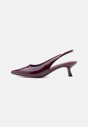 Burgundy patent leather slingback shoe with pointed toe and low kitten heel, shown from the side on a white background.