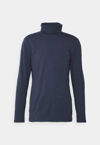 Merenkunnan pitkähihainen poolopaita, joka on valmistettu pehmeästä kankaasta. Paita on istuva ja siinä on korkea, taitettu kaulus. Silkkinen pinta, minimaalinen yksityiskohtaisuus.