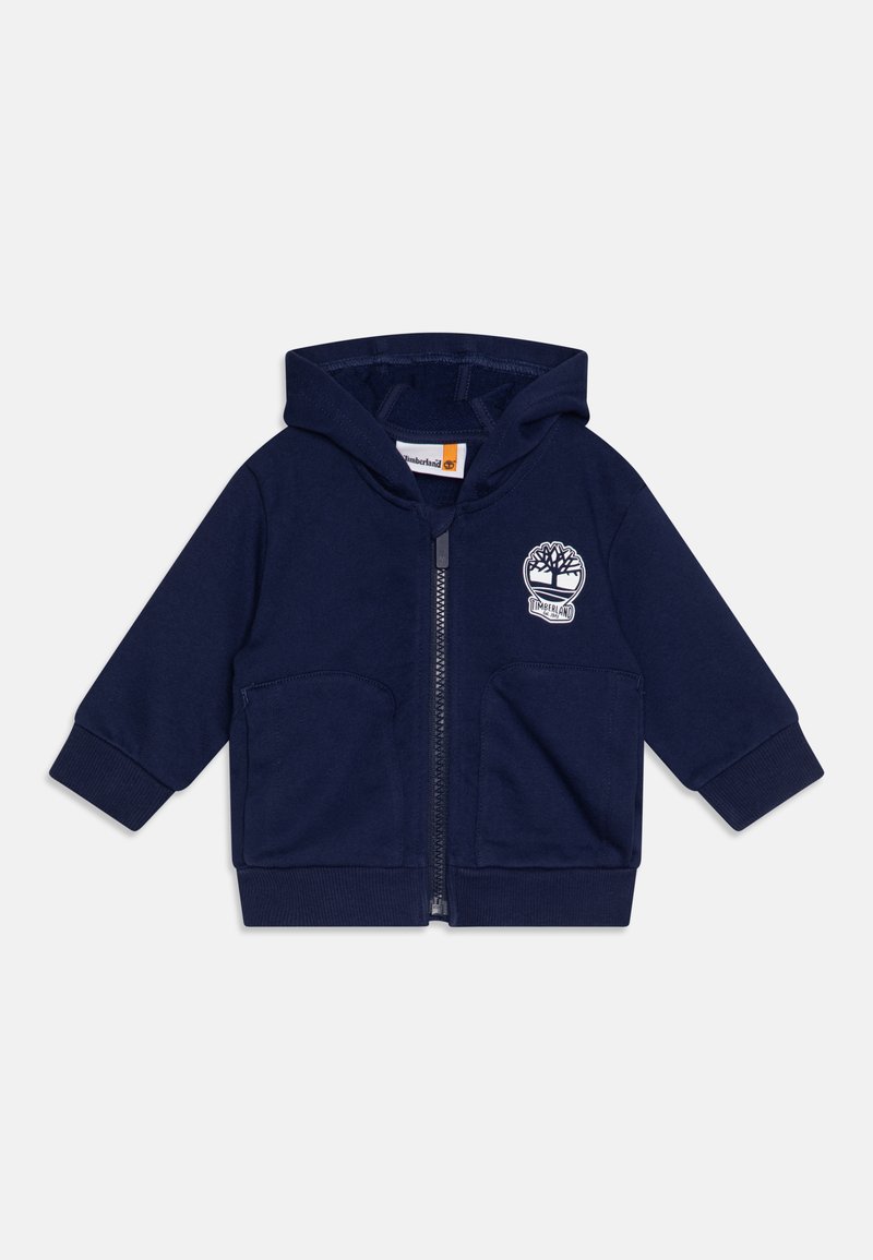 Felpa con zip di colore blu navy in tessuto morbido, con logo frontale, due tasche a marsupio e polsini e orlo a costine. Design classico con cappuccio.