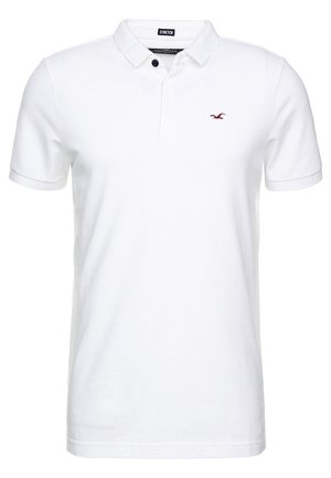 Wit poloshirt met korte mouwen, kraag, twee knopen en een klein rood geborduurd vogellogo op de linkerborst.