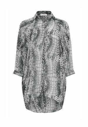 Paita musta-valkoisella käärmeennahkakuviolla, valmistettu kevyestä kankaasta. Varustettu kauluksella, nappisuljennalla ja pitkillä hihoilla, joissa on käännettävät hihansuut.