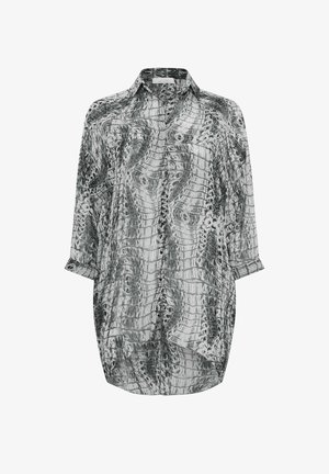 Paita musta-valkoisella käärmeennahkakuviolla, valmistettu kevyestä kankaasta. Varustettu kauluksella, nappisuljennalla ja pitkillä hihoilla, joissa on käännettävät hihansuut.