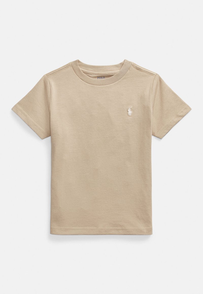 Beige bomulls-t-shirt med korta ärmar och rund halsringning. Har en liten broderad logotyp på vänster bröst. Slät textur.