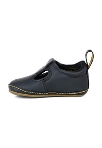 Scarpa nera in pelle con design traforato. Presenta una tomaia testurizzata, cuciture dorate lungo la suola e un cinturino sul retro per facilitare la calzata.