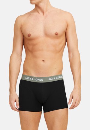 Schwarze Boxershorts mit einem grauen elastischen Bund, auf dem das Logo "JACK & JONES" abgebildet ist. Hergestellt aus glattem Stoff, enganliegendem Design und in Mittellänge bis zum Oberschenkel.