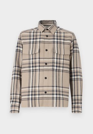 Beige plaid shirt jacket made of woven fabric, featuring two chest pockets, button closure, and black accents in the check pattern.