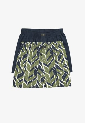 Dos pares de bóxer de hombre, uno liso en azul marino y otro con estampado de hojas verdes y azul marino, ambos con cintura elástica y cierre de botones en la parte delantera.