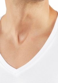 White V-neck t-shirt with a smooth, soft texture. Neckline features a clean seam and slight depth. Skin tone visible under the collar.