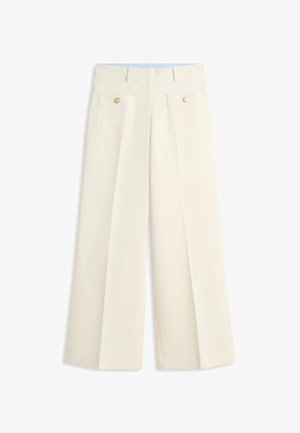 Cream-colored wide-leg pants with high waist, front pleats, two front patch pockets, and gold button details at pocket tops.