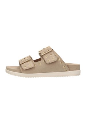 Beige suede slide sandals feature two wide straps with gold-tone hardware and perforations, set on a white cushioned sole.