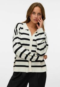 Schwarz-weiß gestreifter Cardigan mit lockerer Passform, Kragen, langen Ärmeln und Knöpfen vorne. Glatte Textur, lässiges Design.