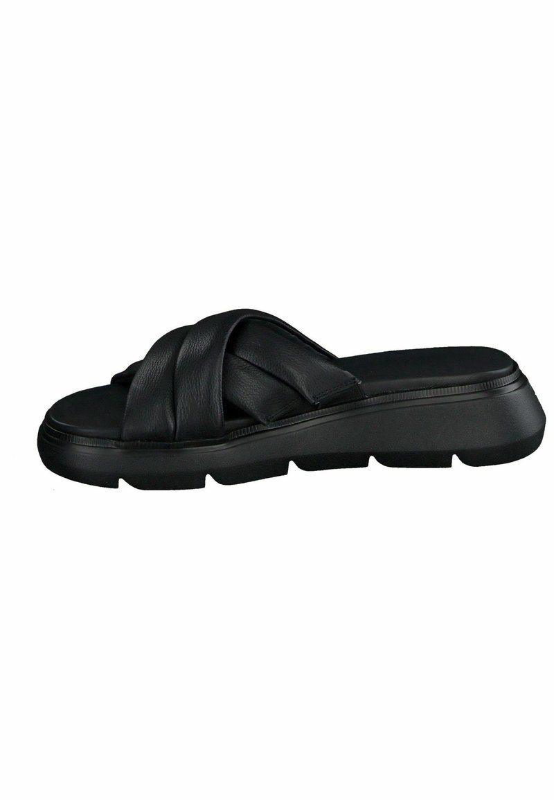Sandal in pelle nera con tre cinturini intrecciati, suola piatta e base texturizzata per una buona presa. Design semplice, forma moderna, accenti minimi.