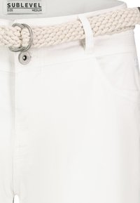 White pants with a smooth texture and subtle stitching details, paired with a braided beige belt featuring a silver circular buckle.