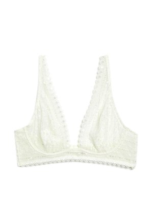 Biała koronkowa braletka z głębokim dekoltem w kształcie litery V, falistymi krawędziami i delikatnymi kwiatowymi wzorami na jednolitym białym tle.