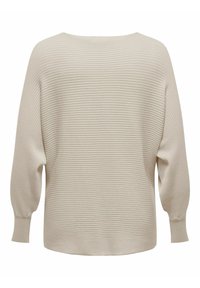 Vaalea beige ribbattu neule, jossa on leveä kaula-aukko ja pallohihat, kuvattu selkäpuolelta valkoista taustaa vasten.