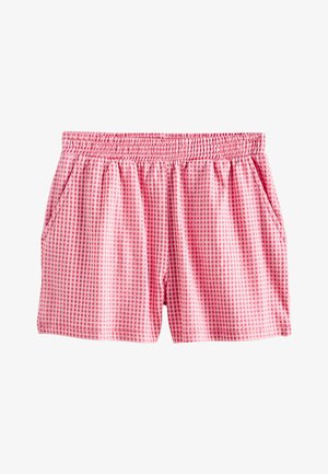 Vaaleanpunaiset elastiset vyötäröshortsit, joissa on pieni ruutukuvio ja sivutaskut, suunniteltu rentoon käyttöön.